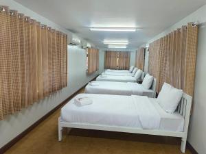 a row of beds in a room with windows at Ake camping pakchong in Ban Khanong Phra Tai +260 photos
