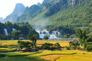 a view of a valley with a waterfall in a mountain at Jeanne Hotel in Cao Bằng
