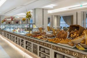 a buffet line with many different types of food at VALY Al-Madinah Hotel in Medina