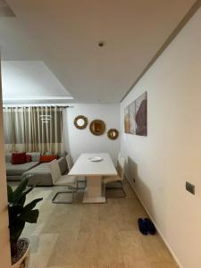 a living room with a white table and a couch at Murcia in Rabat