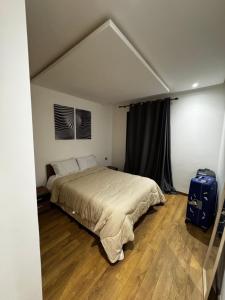 a bedroom with a bed and a blue suitcase at Murcia in Rabat