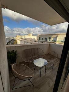 a balcony with two chairs and a table on it at Murcia in Rabat