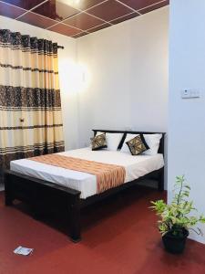 a bedroom with a bed in a room at Shereen Sigiri Homestay in Dambulla