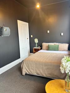 a bedroom with a large bed and a table at Rehutai in Wairoa +10 photos