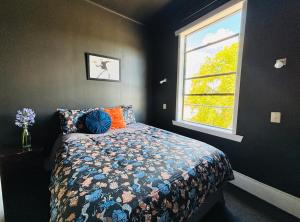 a bedroom with a bed and a window at Rehutai in Wairoa