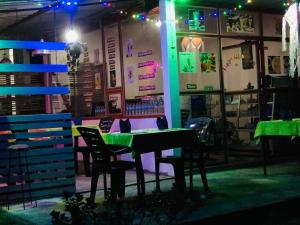 a restaurant with a table and chairs at night at Shereen Sigiri Homestay in Dambulla +10 photos