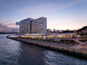 a large building next to a body of water at RISONARE Shimonoseki in Shimonoseki