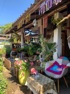 a store with a table and chairs and flowers at Ka Prao Kai Hostel in Pai