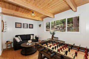 a living room with a foosball table at Yama Cabin - 5 min walk to the village, EV plug, hot tub, kid & pet friendly in Lake Arrowhead