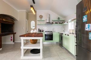 a kitchen with green cabinets and a counter in it at Abalone Hotel & Villas 2 Bedroom Apartment in Paternoster