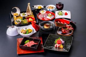 a table with many plates of food on it at Tokiwa Hotel in Kofu