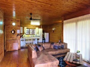 a living room with a couch and a kitchen at Viewpoint Lodge & Safari Tours in Hazyview