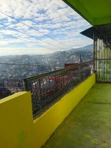 a yellow ledge with a view of a city at iya lee guest hauz in Capissayan