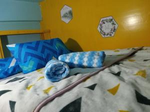 a bed with a comforter and pillows on it at iya lee guest hauz in Capissayan