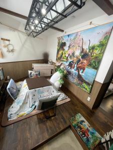 a bedroom with a large painting on the wall at 恐竜博物館まで車で5分 自然体験 古来農業体験ができる一棟貸し宿Dinosaur Agri in Katsuyama