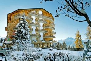 a building with a snow covered tree in front of it at Appartement - Bristol Hôtel in Villars-sur-Ollon