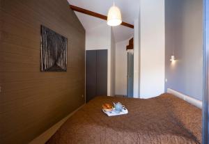 a bedroom with a bed with a tray of food on it at Les Granges de Leo in Aston +61 photos