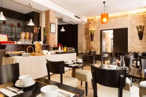 a restaurant with tables and chairs and a counter at Europe Saint Severin-Paris Notre Dame in Paris +29 photos