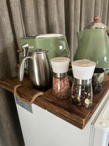 a wooden shelf with various kitchen items on top of a refrigerator at The Garden Room in Clyde