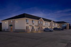 a large building with cars parked in a parking lot at Quality Inn Beaver I-15 in Beaver