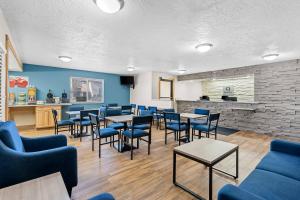 a waiting room with tables and blue chairs at Quality Inn Beaver I-15 in Beaver