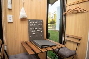 a laptop sitting on a table in a tiny house at The Orchard View by Tiny Away in Nashdale