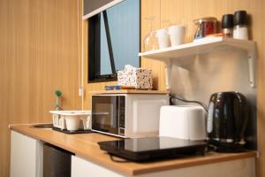 a microwave sitting on a counter in a kitchen at The Orchard View by Tiny Away in Nashdale