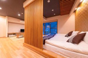 a large bed in a room with a large mirror at Tsukasa Ryokan in Saga +49 photos