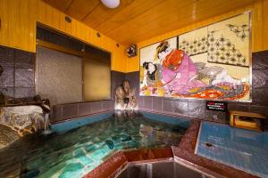 a swimming pool in a room with a pool at Tsukasa Ryokan in Saga