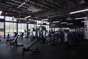 a gym with several treadmills and machines in it at Global Backpackers Youth Hostel in Cairns
