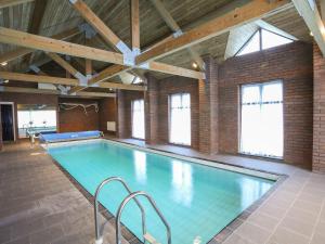 a large swimming pool in a brick building at Bryn Eira Tack Room in Llanfairpwllgwyngyll