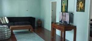 a living room with a couch and a table at Mountain View Garden House in Ban Chong Phli