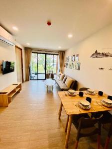 a living room with a table and a couch at Bann Chidtha family suite full kitchen near Suvarnabhumi Airport in Bangkok