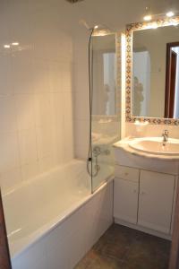 a bathroom with a tub and a sink and a shower at Palm Bay Apartment in Luz +41 photos