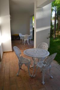a patio with a table and chairs on a patio at Palm Bay Apartment in Luz