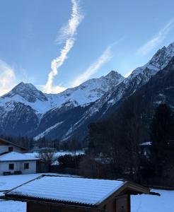 a snow covered mountain range with a house in front at 6444 Apartment in Unterlängenfeld +4 photos
