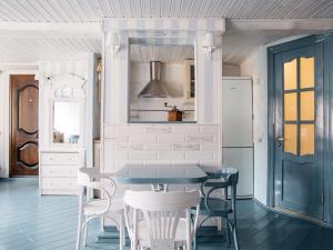 a dining room with a blue table and chairs at Studio on Morskaya 25 in Saint Petersburg