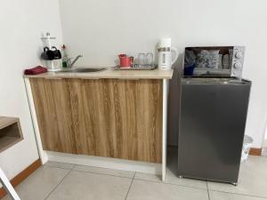 a kitchen counter with a sink and a microwave at The Minimalist Suite in Kempton Park