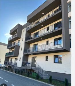 an apartment building with balconies on the side of a street at Apart 1 Dragonul Rosu - Spital Fundeni in Dobroeşti