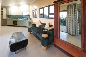 a living room with a couch and a table at Fourfields Hogsback in Hogsback