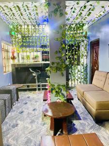 a living room with a couch and a table at JEVENOM HOTEL in Ibafo