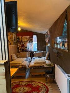a room with four beds and a tv in it at My cosy space in Spa
