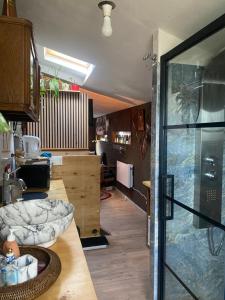 a kitchen with a counter and a glass door at My cosy space in Spa +3 photos