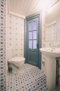 a bathroom with a toilet and a sink at Studio on Morskaya 25 in Saint Petersburg