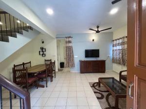 a living room with a table and a tv at The golden villa in Calangute