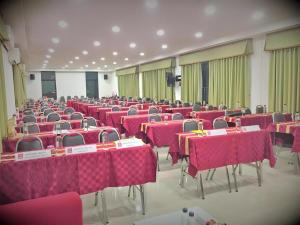 a room full of tables and chairs with pink table cloth at Breeze Hill Resort in Campson +137 photos