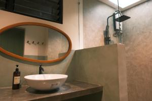 a bathroom with a bowl sink and a mirror at Easy Does It Guesthouse Siargao in General Luna
