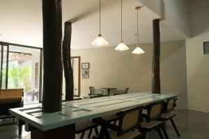 a dining room with a blue table and chairs at Easy Does It Guesthouse Siargao in General Luna +22 photos