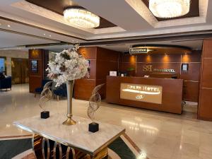a lobby with a table with flowers on it at Sparr Hotel in Amman