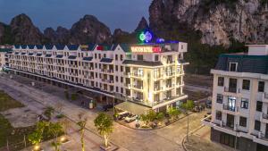 a rendering of a hotel with a mountain in the background at Van Don Royal Hotel in Hà Cái